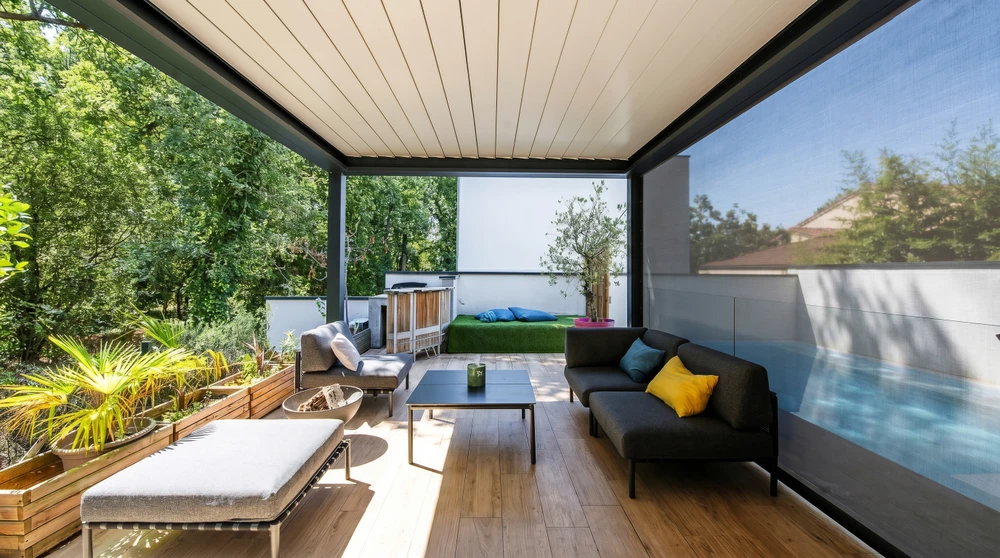 Terrasse couverte moderne avec pergola bioclimatique à lames orientables, structure aluminium anthracite, plafond à lames blanches